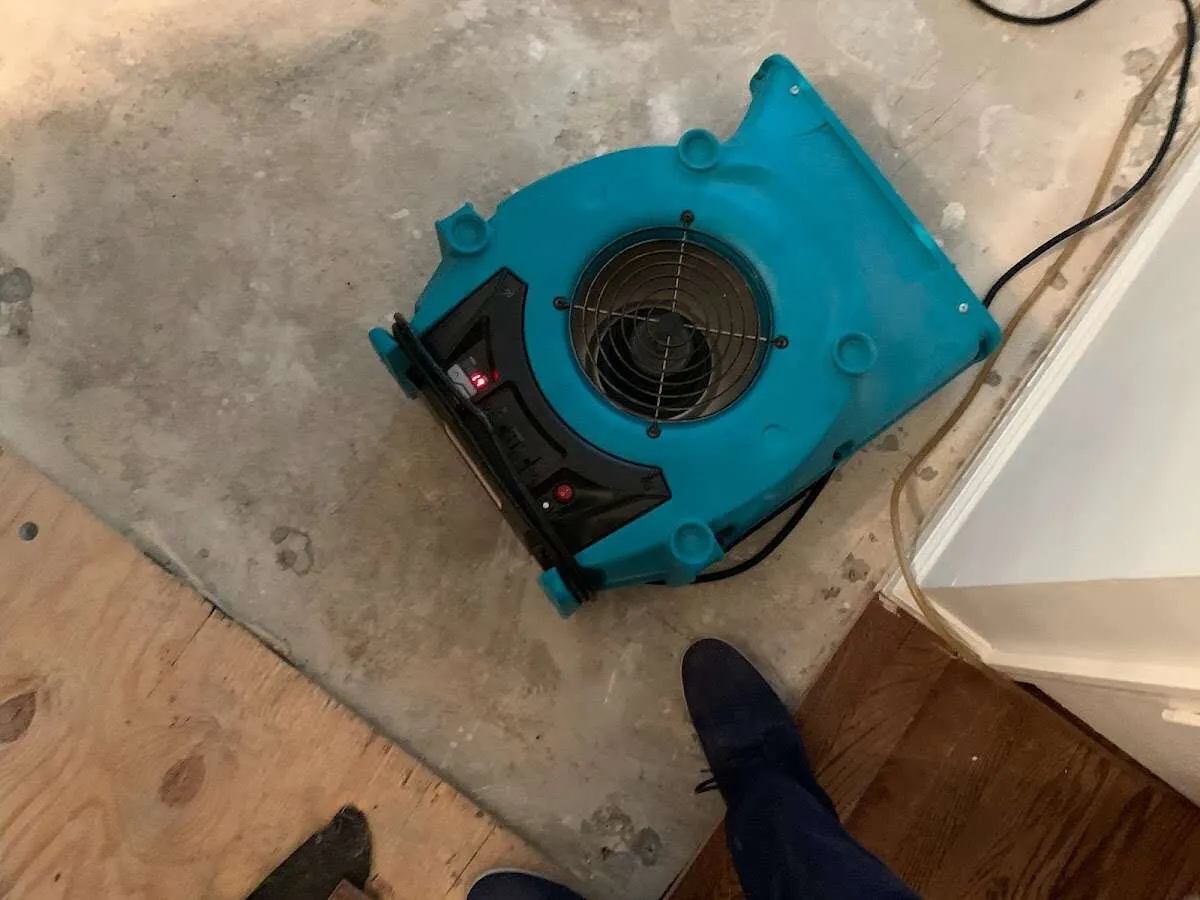 Air mover drying subfloor during Commercial Water Damage Restoration in West Manchester